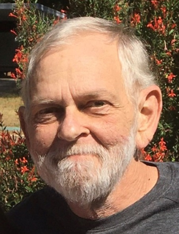 John Rittelmeyer, who was gentle yet fierce. John was an older white male, with gray hair and beard, who passed away in 2019.