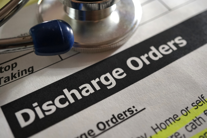 Paperwork for discharge, zoomed in on the words, "Discharge orders" with a stethoscope resting on top.