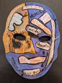 Yellow and blue mask with words Suicide, Homeless, Be Quiet, Get Out 