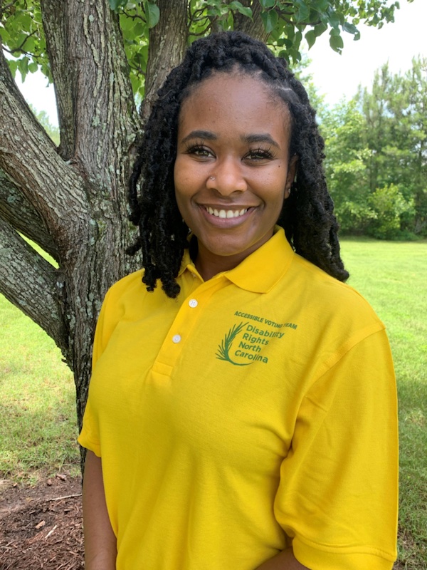 young Black woman wearing yellow DRNC polo shirt