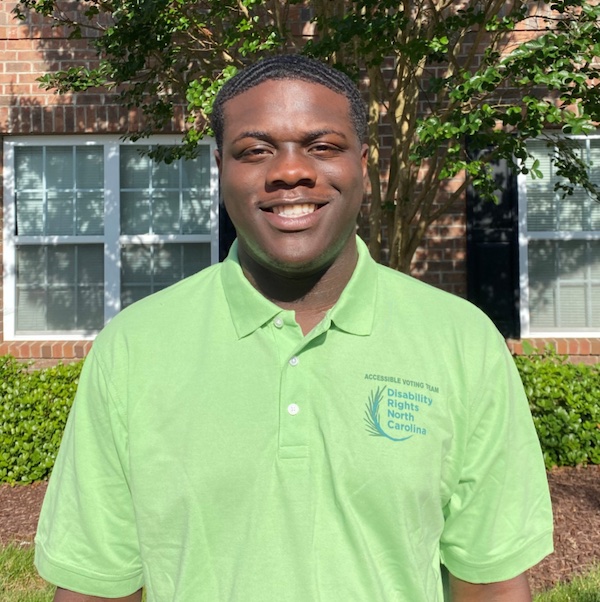 Smiling Young Black man wearing green polo shirt with DRNC logo