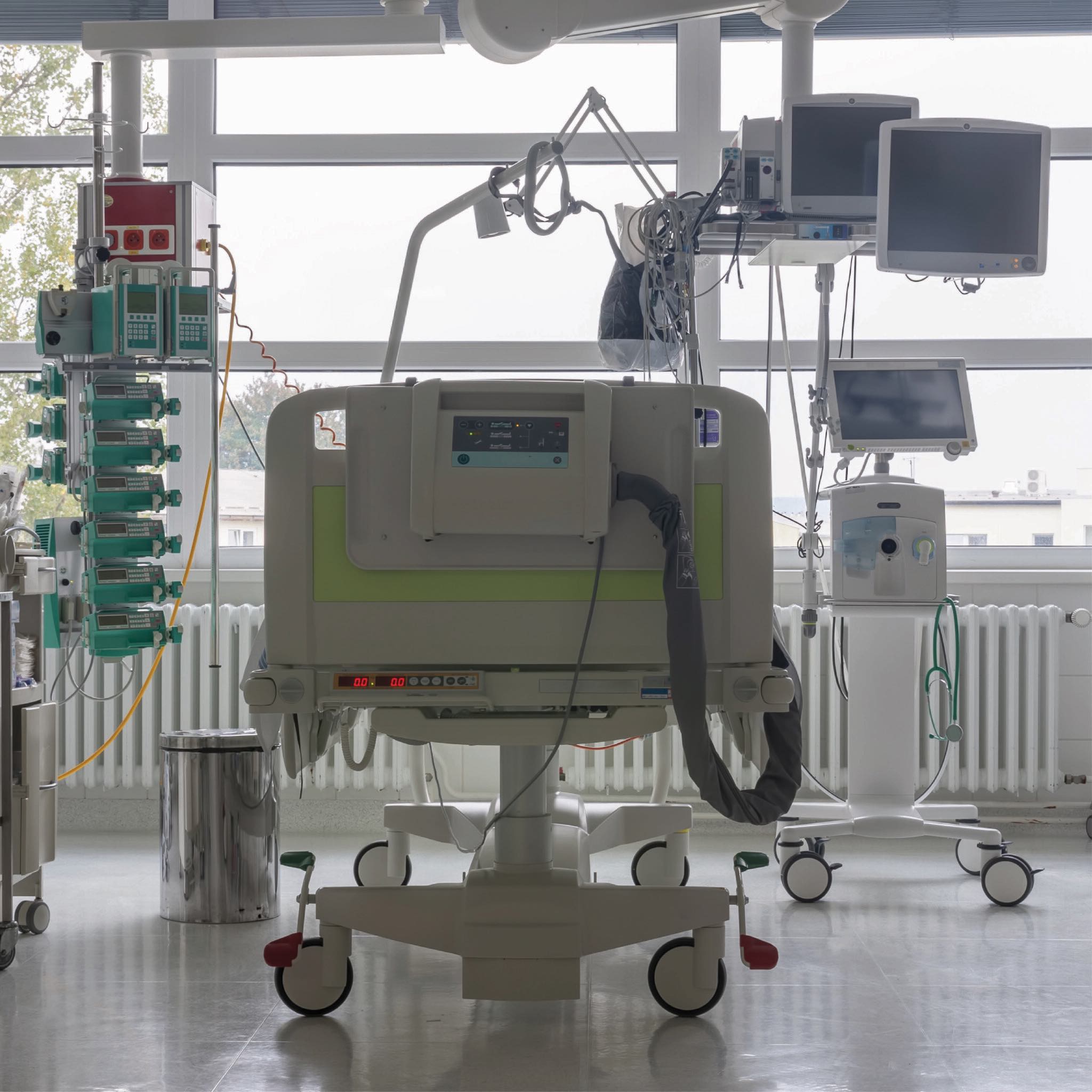 image of a room in ICU, hospital bed and medical equipment framed by a window