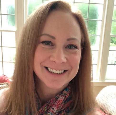 Professional headshot of Amy Heimel - a light skin brown hair female with blue eyes