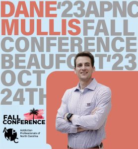 A man standing with his arms crossed in front of text about the APNC Conference.