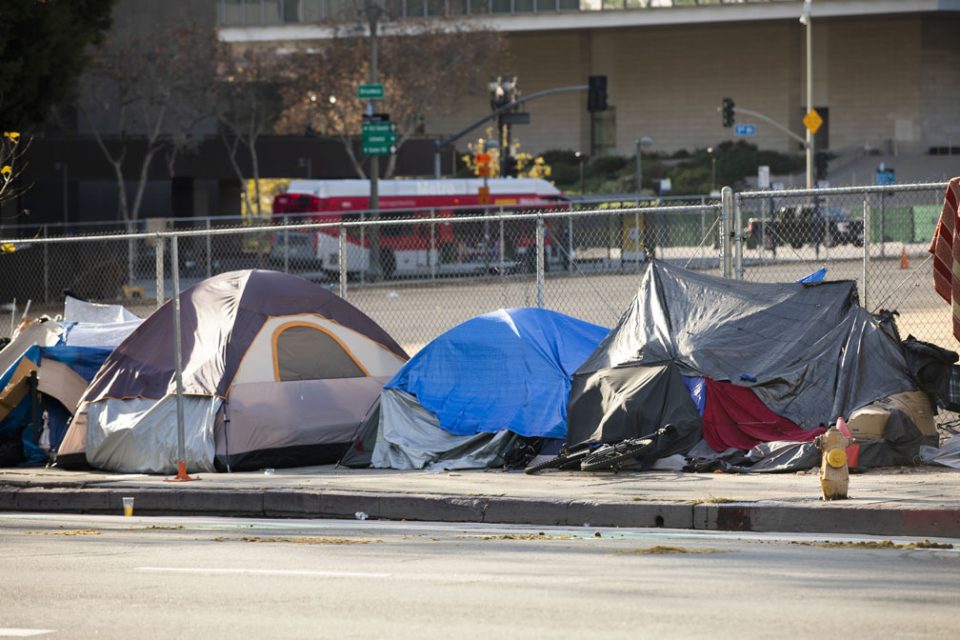 A homeless encampment sits on a street