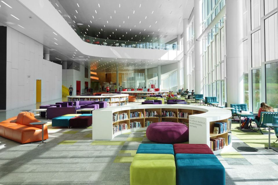 Colorful chairs and books on low bookshelves inside the James B Hunt library on Centennial Campus of the NC State University in Raleigh NC