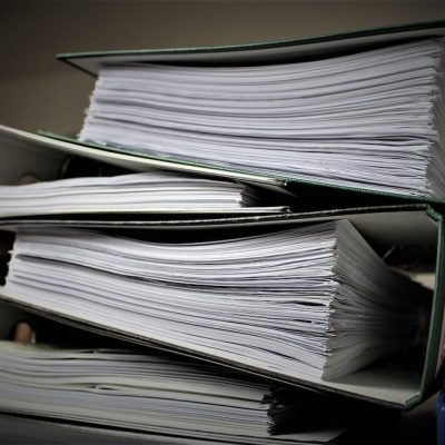 Three large binders full of documents