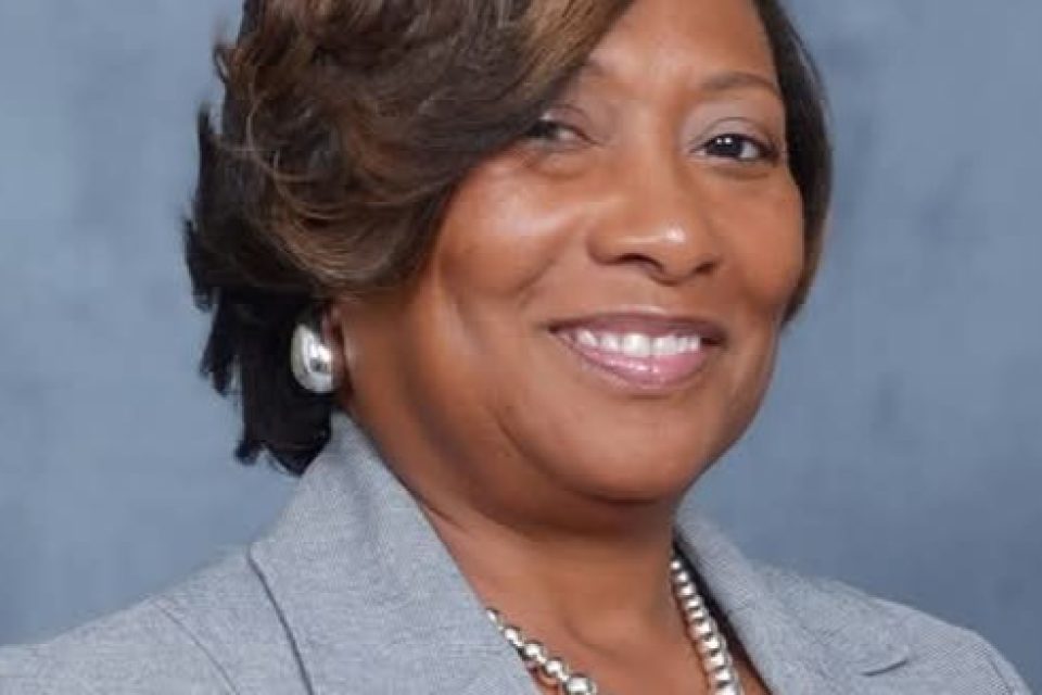 Barbara Daniels wearing a gray blazer and pearls