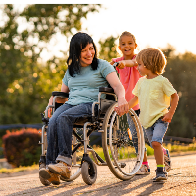 A woman in a wheelchair traveling down a a path with two children