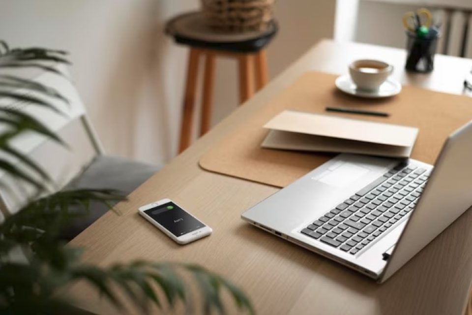 Home desk with laptop and notebooks