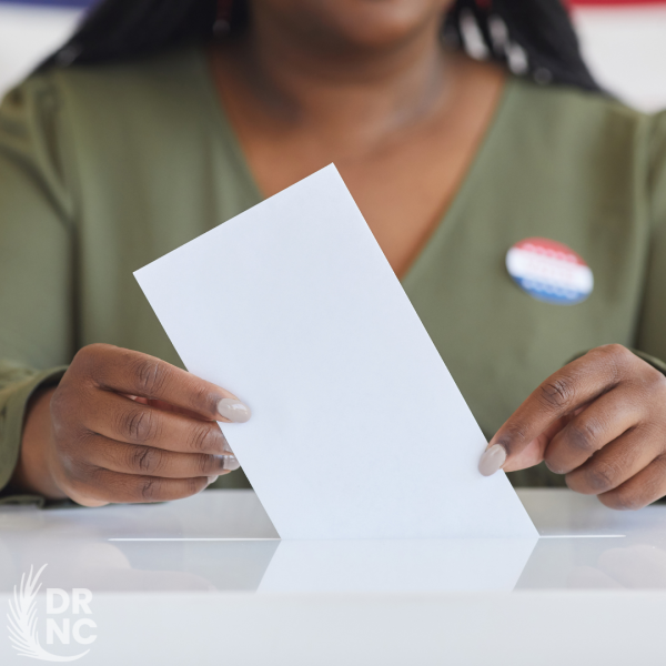 Woman placing ballot in box