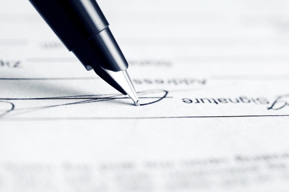 pen placed on signature line, signing a letter requesting workplace accommodations