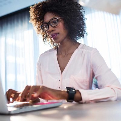 Black woman works on laptop