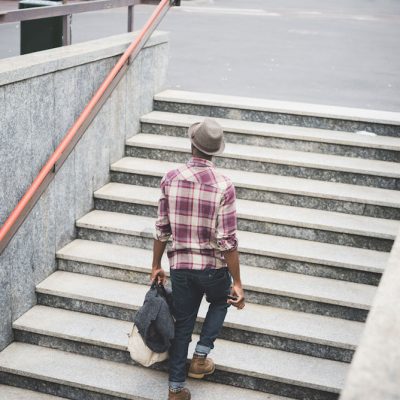 black man walks up a flight of stairs