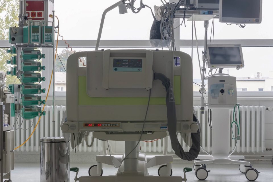 image of a room in ICU, hospital bed and medical equipment framed by a window