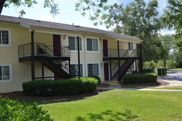 two story yellow apartment building with 4 units