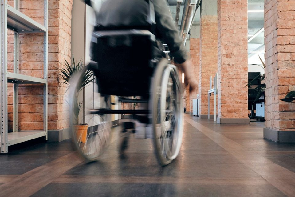 blurred image of man using wheelchair