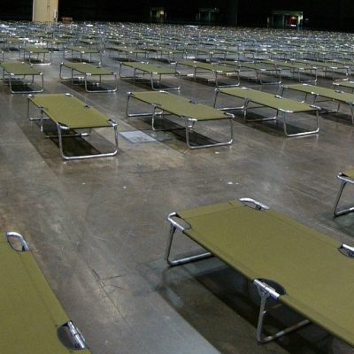 rows of cots in an emergency shelter