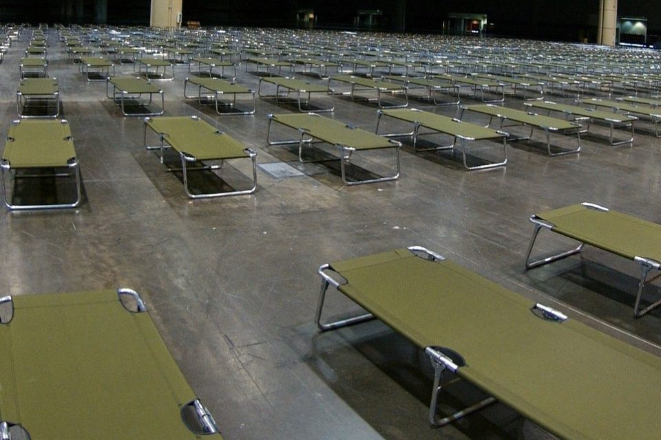 rows of cots in an emergency shelter