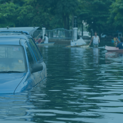 Flooded street with partially submerged vehicle