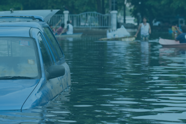 Flooded street with partially submerged vehicle