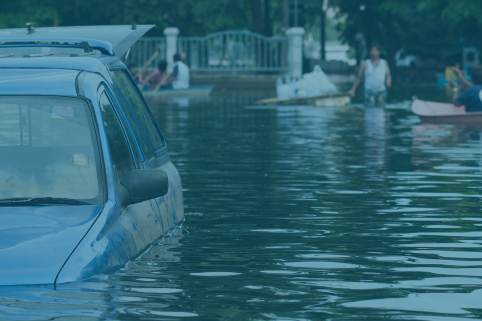 Flooded street with partially submerged vehicle